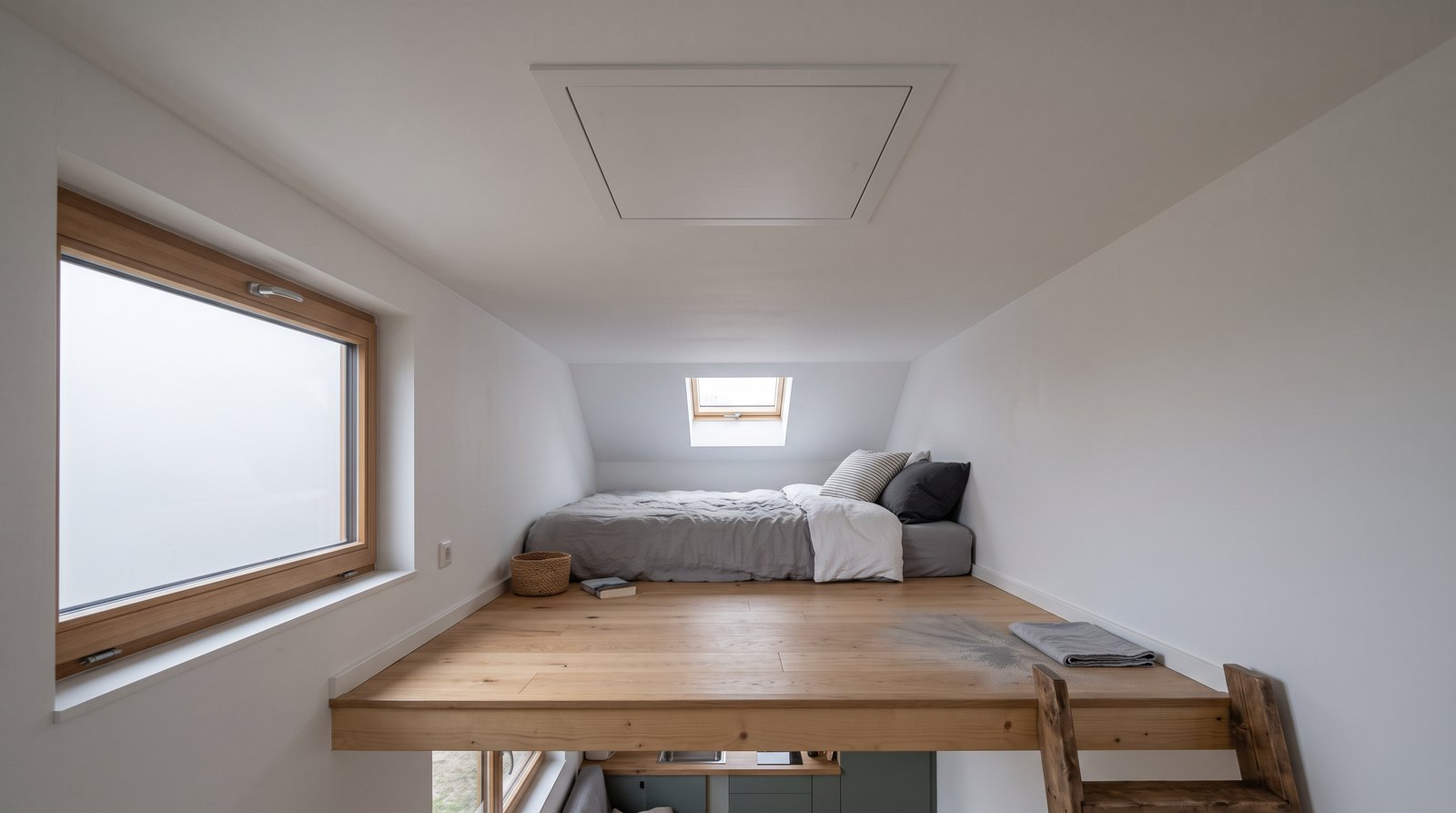Tiny house loft with a smooth painted drywall ceiling and access hatch
