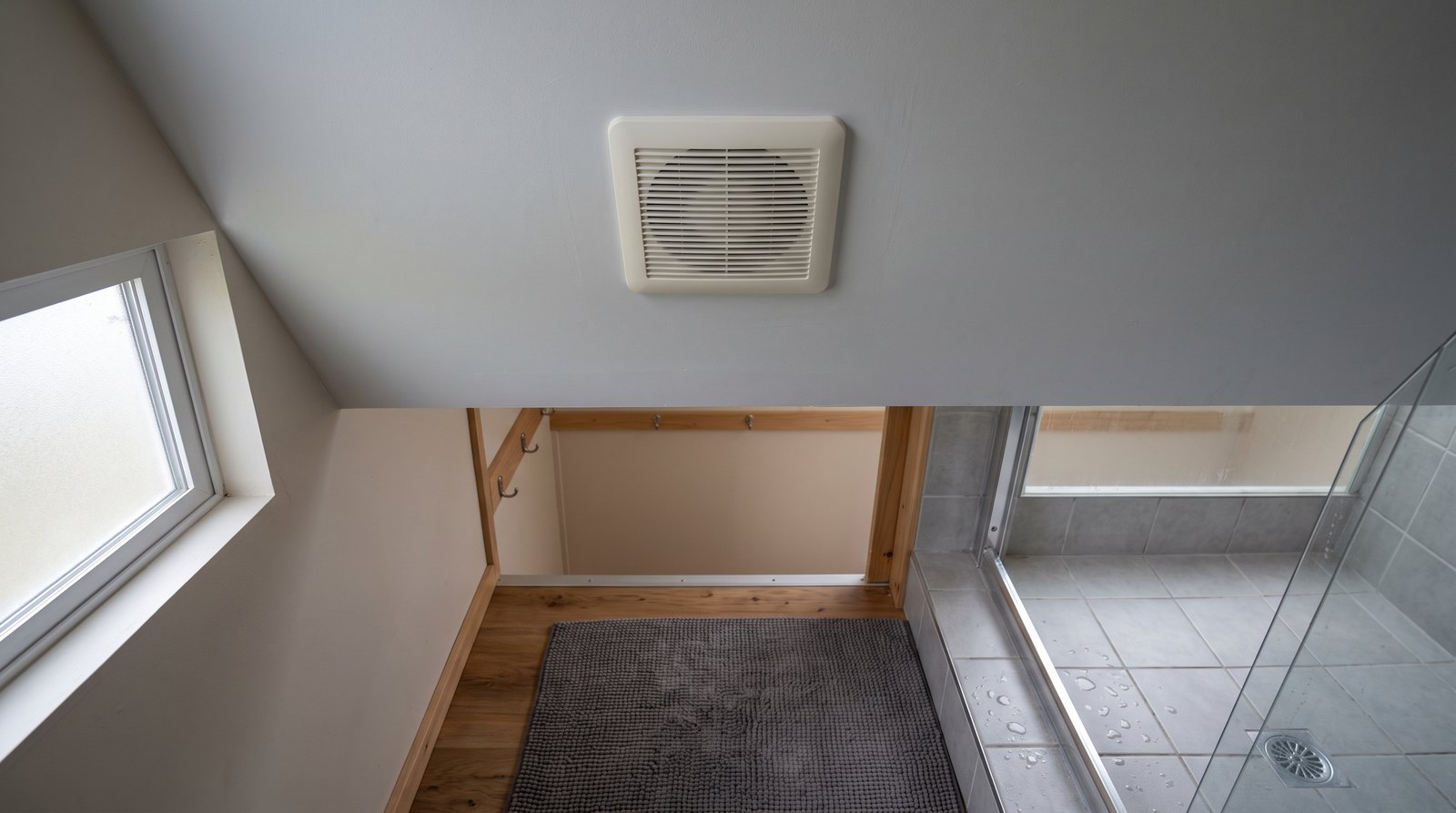 Ceiling exhaust fan in a compact tiny house bathroom